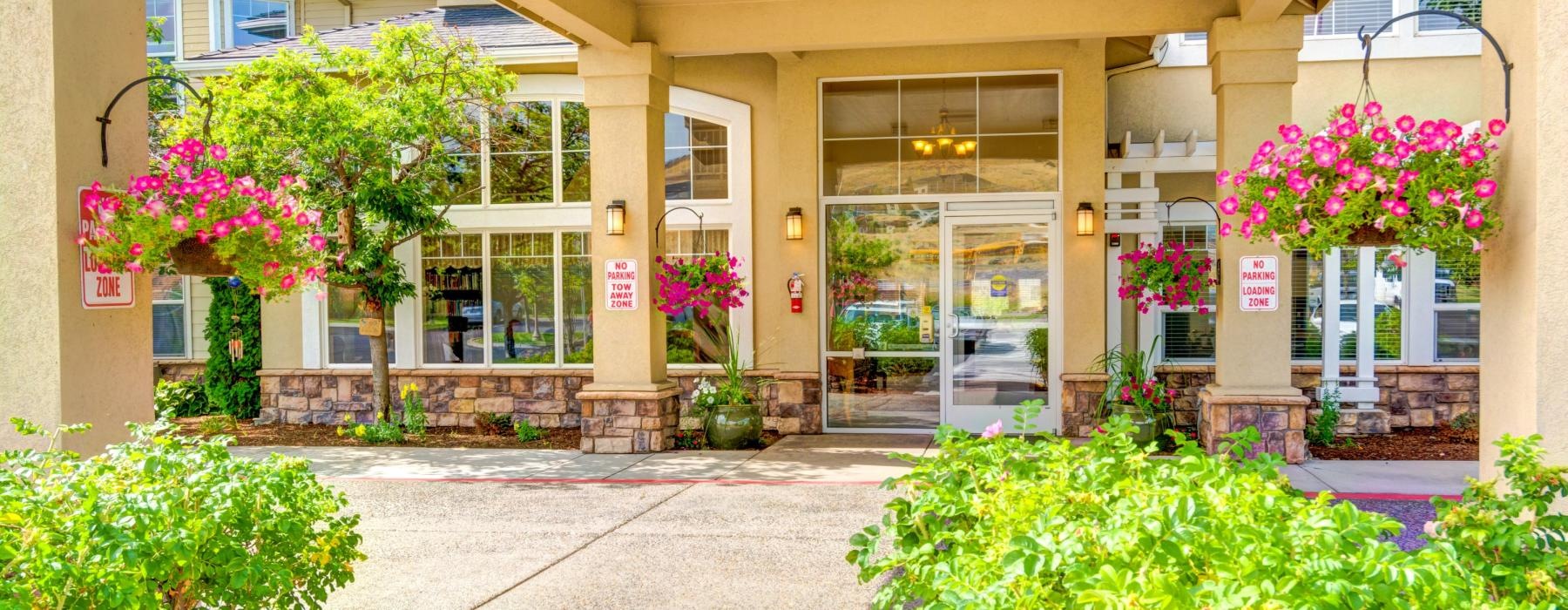 a building with a glass front door and a flower bed