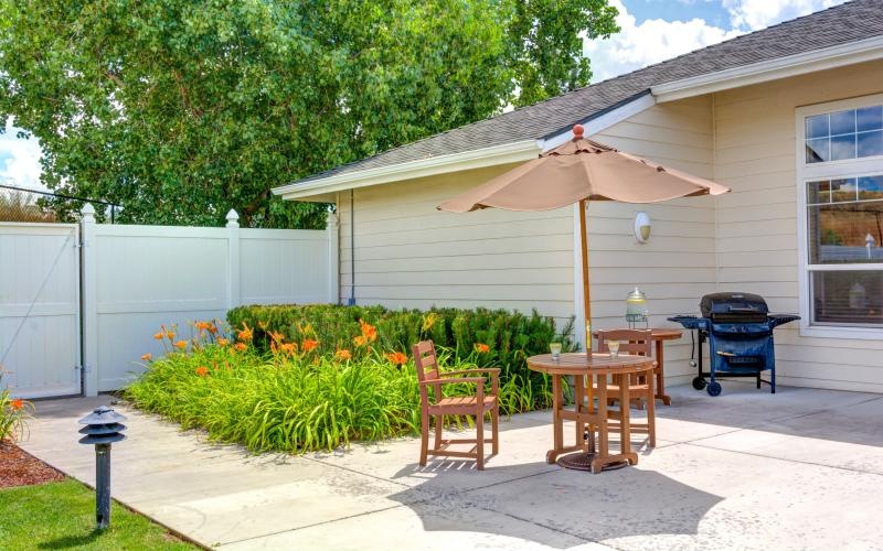 a patio with a table and chairs